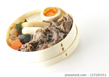 Sukiyaki bento box with plenty of ingredients photographed against a white background Sukiyaki bento box with plenty of ingredients photographed against a white background 137285351