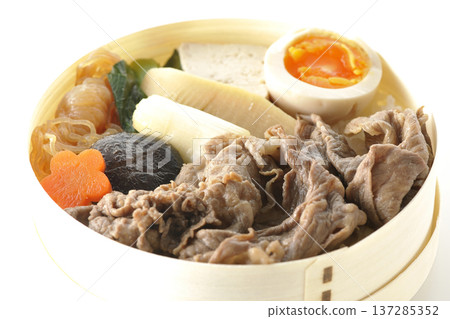 Sukiyaki bento box with plenty of ingredients photographed against a white background Sukiyaki bento box with plenty of ingredients photographed against a white background 137285352