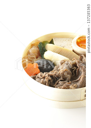 Sukiyaki bento box with plenty of ingredients photographed against a white background Sukiyaki bento box with plenty of ingredients photographed against a white background 137285363