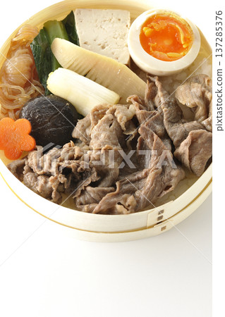 Sukiyaki bento box with plenty of ingredients photographed against a white background Sukiyaki bento box with plenty of ingredients photographed against a white background 137285376