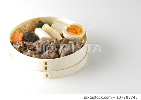 Sukiyaki bento box with plenty of ingredients photographed against a white background Sukiyaki bento box with plenty of ingredients photographed against a white background 137285743