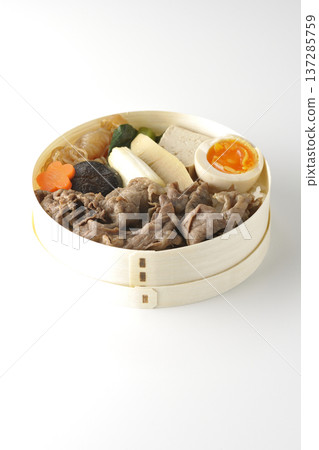 Sukiyaki bento box with plenty of ingredients photographed against a white background Sukiyaki bento box with plenty of ingredients photographed against a white background 137285759