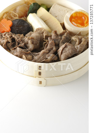 Sukiyaki bento box with plenty of ingredients photographed against a white background Sukiyaki bento box with plenty of ingredients photographed against a white background 137285771