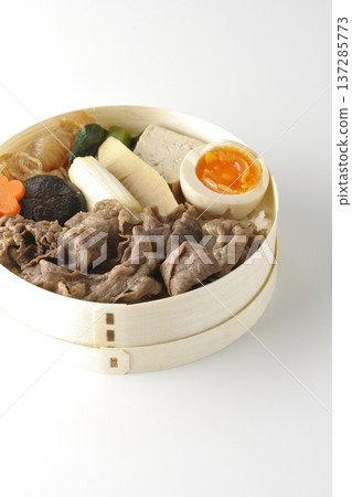 Sukiyaki bento box with plenty of ingredients photographed against a white background Sukiyaki bento box with plenty of ingredients photographed against a white background 137285773