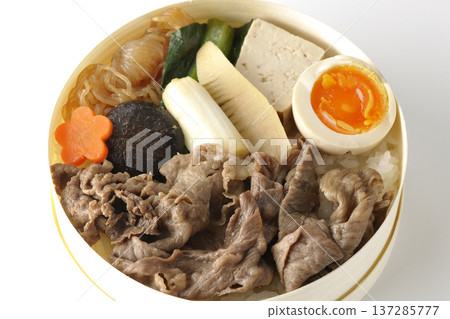 Sukiyaki bento box with plenty of ingredients photographed against a white background Sukiyaki bento box with plenty of ingredients photographed against a white background 137285777