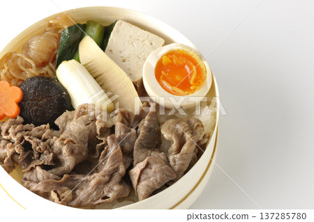 Sukiyaki bento box with plenty of ingredients photographed against a white background Sukiyaki bento box with plenty of ingredients photographed against a white background 137285780