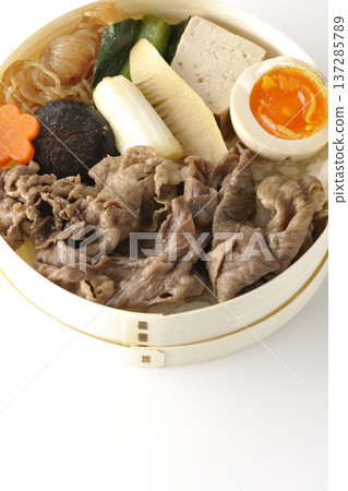 Sukiyaki bento box with plenty of ingredients photographed against a white background Sukiyaki bento box with plenty of ingredients photographed against a white background 137285789
