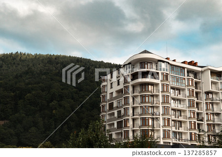 Modern Apartment Building in Mountain Landscape Modern Apartment Building in Mountain Landscape 137285857