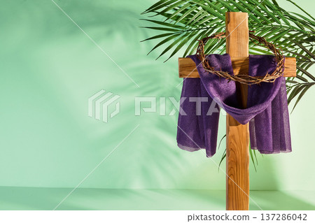 Cross with crown of thorns and purple fabric symbolizing palm sunday Cross with crown of thorns and purple fabric symbolizing palm sunday 137286042