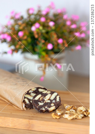 Chocolate salami sausage on wooden board Chocolate salami sausage on wooden board 137286253