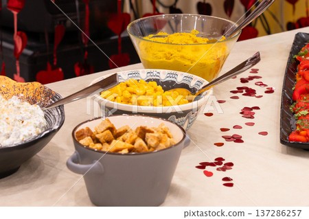 Buffet table with croutons, corn and hummus 137286257