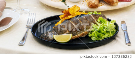 Roast trout with potatoes and lettuce salad banner Roast trout with potatoes and lettuce salad banner 137286283