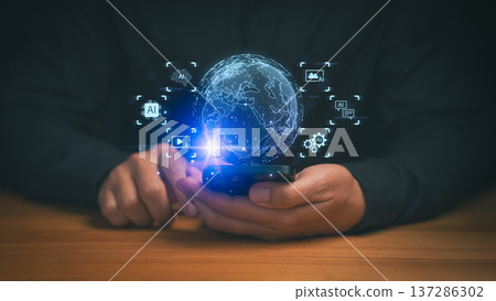 Person using a smartphone with a glowing digital globe and AI icons, representing global connectivity, artificial intelligence, data integration, smart technology, and advanced mobile innovation. Person using a smartphone with a glowing digital globe and AI icons, representing global connectivity, artificial intelligence, data integration, smart technology, and advanced mobile innovation. 137286302
