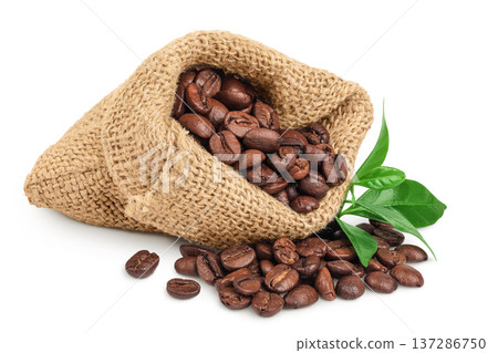 Coffee beans in burlap bag with leaf isolated on white background 137286750