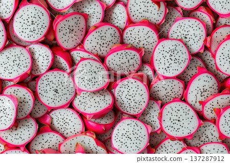 Close-Up of Fresh Dragon Fruit Slices Layered on a Vibrant Background Close-Up of Fresh Dragon Fruit Slices Layered on a Vibrant Background 137287912