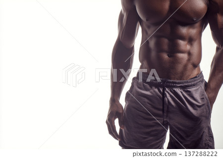 muscular man front view showing sculpted abs on pure white background, casual gym shorts, diffused 137288222