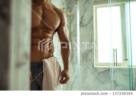 muscular man front view showing abs in luxury bathroom interior, marble textures, soft natural 137288384