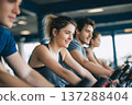 group of teens doing light cardio training on stationary bikes, gym background, energetic lifestyle 137288404