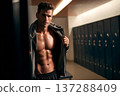 athletic man with defined abs holding sports jacket over shoulder in locker room, clean bright 137288409
