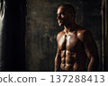 fit male front facing with defined abs in boxing gym environment, gritty atmosphere, dramatic side 137288413