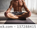 fit man with toned abs sitting on yoga mat in bright wellness studio, natural daylight, calm 137288415
