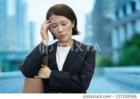 Businesswoman with a tired expression 137288566