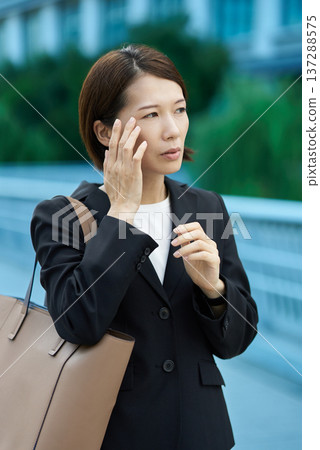 Businesswoman with a tired expression 137288575
