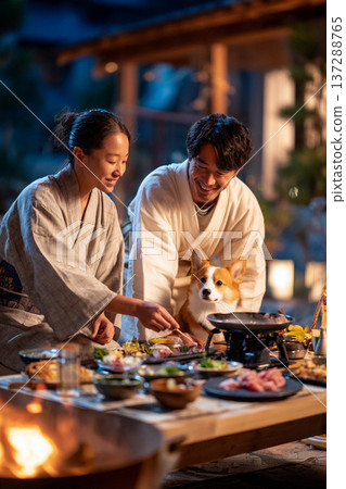 A couple and a corgi enjoying dinner at a ryokan inn 137288765