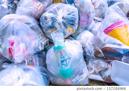 Yokohama cityscape in Japan. Plastic garbage piles up in a garbage dump on a street corner. Plastic container and packaging collection day, March 4, Yokohama. Yokohama cityscape in Japan. Plastic garbage piles up in a garbage dump on a street corner. Plastic container and packaging collection day, March 4, Yokohama. 137288966
