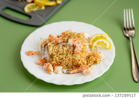 healthy bulgur with shrimp and lemon garnish healthy bulgur with shrimp and lemon garnish 137289517