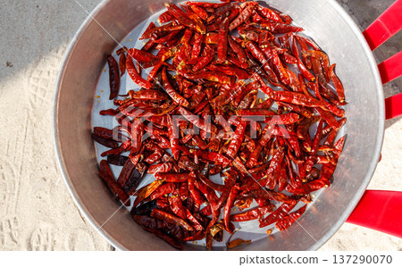 Red chilies in a metal pan, sunlit, vibrant Red chilies in a metal pan, sunlit, vibrant 137290070