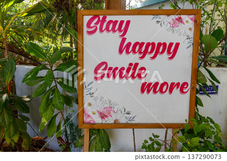 Pink letters on a white board urge joy and smiles Pink letters on a white board urge joy and smiles 137290073