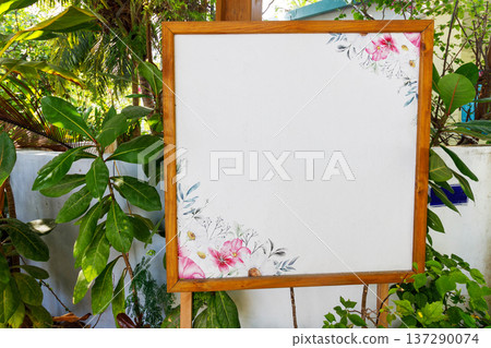 Wooden signboard stands in lush garden setting Wooden signboard stands in lush garden setting 137290074