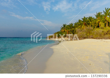 Soft sand meets calm turquoise waves Soft sand meets calm turquoise waves 137290336
