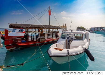 Clear turquoise water holds two boats Clear turquoise water holds two boats 137290359