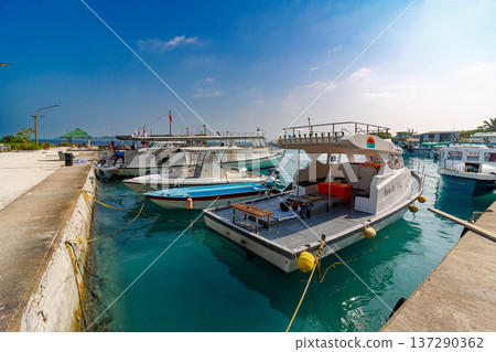 Clear blue waters hug docked yachts 137290362