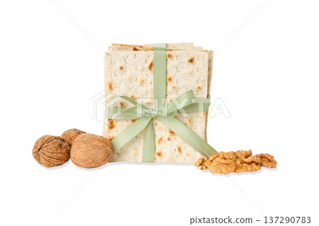 Matzah with ribbon next to walnuts and pecans, isolated, PNG Matzah with ribbon next to walnuts and pecans, isolated, PNG 137290783