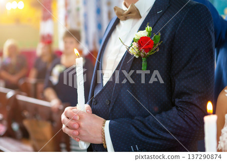 Bride and groom holding the candles. Close up. Bride and groom holding the candles. Close up. 137290874
