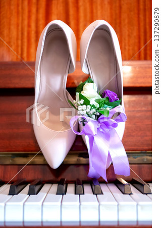 bride's shoes on the piano, bride's bouquet. wedding attributes. bride's shoes on the piano, bride's bouquet. wedding attributes. 137290879