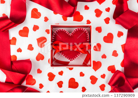 background to Valentine's Day or romantic event. heart in the gift box against the background of the hearts. background to Valentine's Day or romantic event. heart in the gift box against the background of the hearts. 137290909