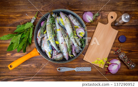 fresh fish perch in a saucepan with spices, top view. place for text 137290952