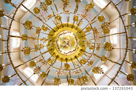 ceiling in the church with the illuminator. church lamp look from below ceiling in the church with the illuminator. church lamp look from below 137291043