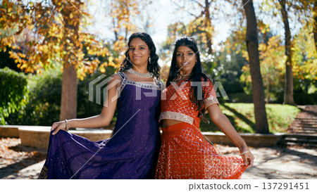 Indian women smiling wearing traditional dresses in park 137291451