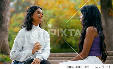 Indian friends enjoying coffee outdoors in autumn 137291471