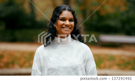 Indian woman smiling enjoying autumn season outdoors 137291492