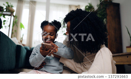 Young child learning using smartphone with mother 137291663