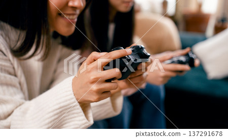 Young women playing video games enjoying leisure time 137291678