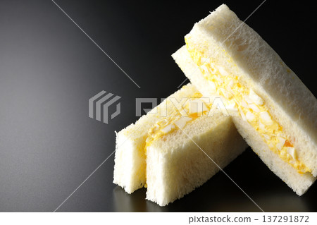 Egg sandwich photographed against a black background Egg sandwich photographed against a black background 137291872