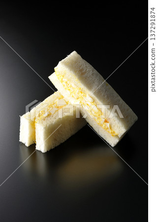 Egg sandwich photographed against a black background Egg sandwich photographed against a black background 137291874