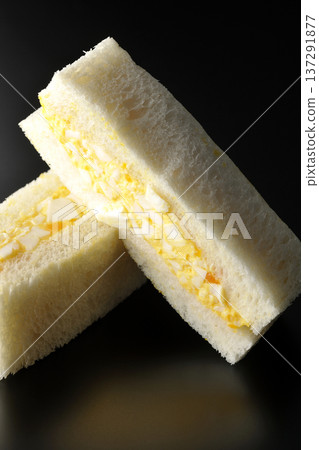 Egg sandwich photographed against a black background Egg sandwich photographed against a black background 137291877